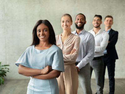 Business Team. Black Female Boss Posing With Her Employees In Office, Confident Young Multiethnic Coworkers Standing In A Row And Smiling At Camera, Enjoying Modern Entrepreneurship, Copy Space